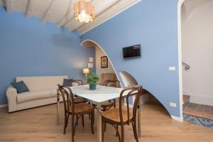 a dining room with a table and chairs and a couch at La casetta di Maria alla Ciba in Termini Imerese +10 photos
