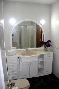 a white bathroom with a sink and a mirror at El piso de Manuela VUT-CO-004057 in Padrón