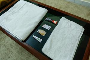 a table topped with white towels and toothbrushes at Belljem Homes -your own private resort -3 BHK GF in Trichūr