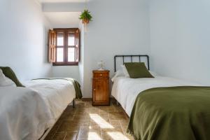 מיטה או מיטות בחדר ב-La Casa Rural Málaga, Caminito del Rey