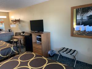 a hotel room with a bed and a flat screen tv at Super 8 by Wyndham Petoskey in Petoskey
