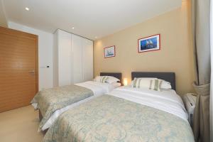 a hotel room with two beds in a room at Villa Manda Zadar Luxury Apartments in Zadar