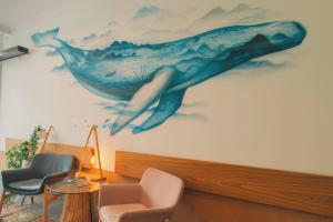 a mural of a whale on the wall of a room at Inn OZZ Astana in Astana