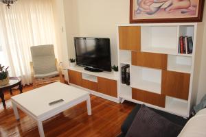 a living room with a tv and a coffee table at El piso de Manuela VUT-CO-004057 in Padrón