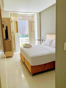 a bedroom with a bed and a window at Hotel Gallery Cartagena in Cartagena de Indias