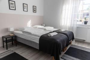 a bedroom with a bed with two towels on it at W Sercu Mazur in Harsz