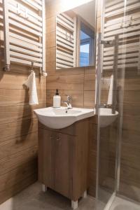 a bathroom with a sink and a mirror at W Sercu Mazur in Harsz +44 photos