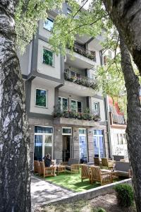 a building with chairs and tables in front of it at Respect034 in Arandelovac