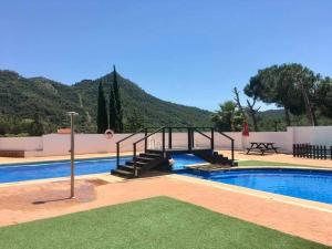a swimming pool with a stairway leading to a resort at espai Abadia in Argentera