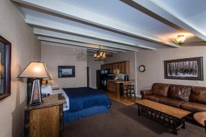 a living room with a bed and a couch at Windjammer Lodge in Ogdensburg