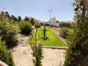La FloridaにあるAppartement avec Solariumの緑の芝生のベンチ付き公園