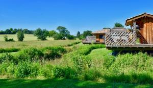 a house in the middle of a field at Chalets CASABELLA in Casteljaloux