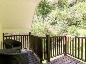 un porche con vistas al bosque en Waterfall Apartment en Inverness