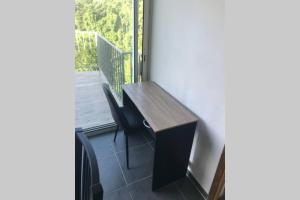 a wooden bench sitting in front of a window at vacances au vert in Baillif
