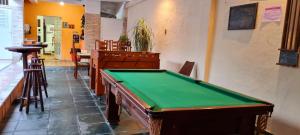 a pool table in a room with a bar at Pousada Sao Paulo in Vila Muriqui