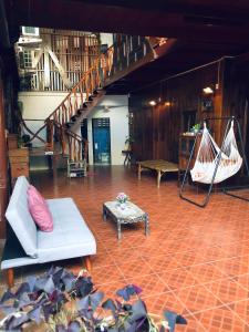 a living room with a couch and a table at Banthai Guesthouse in Phetchaburi