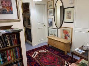 a hallway with a mirror and a bench and a rug at geraldsplace in Edinburgh