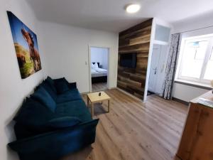 a living room with a couch and a bedroom at Appartement Tauernlife in Schwarzach im Pongau