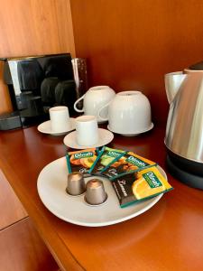 a table with a plate of food and a tea pot at A01 Sétány-Silverine Apartmanház-Őrzött parkolóval in Balatonfüred