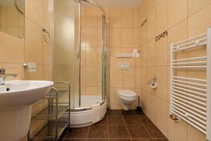 a bathroom with a toilet and a sink and a shower at Holiday House Europa in Rewal +61 photos