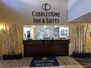 a store with a sign that reads colitisine inn and suites at Cobblestone Inn & Suites - Merrill in Merrill