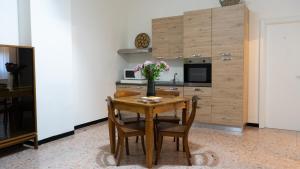 a kitchen with a wooden table with a vase of flowers on it at CASA ARISTON in Sassari
