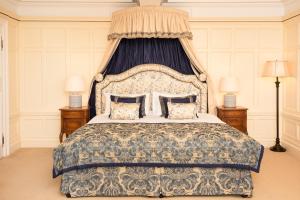 a bedroom with a large bed with a canopy at Springkell in Eaglesfield