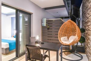 a room with a table and a chair and a bedroom at Oasis in Sarti
