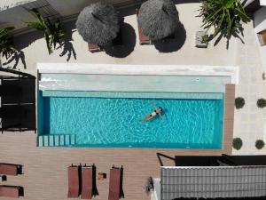 a person is swimming in a swimming pool at Villa Huruma in Paje