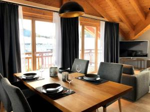 a dining room with a table with chairs at Chalet Bergzeit in Seefeld in Tirol