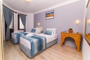 A bed or beds in a room at Dalyan Hotel Nish Caria