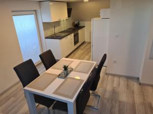 a kitchen and dining room with a table and chairs at Rok Apartment in Bled