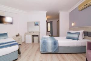 Ein Bett oder Betten in einem Zimmer der Unterkunft Dalyan Hotel Nish Caria
