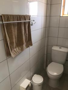 a bathroom with a toilet and a towel at Villa John in Borsh +16 photos