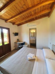 a bedroom with a large bed with a wooden ceiling at Affittacamere Samar in San Teodoro