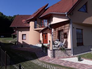a large house with a patio in front of it at Marika Apartmanház in Zalakaros
