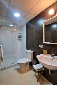 a bathroom with a toilet and a sink and a shower at Alameda11 in Cádiz
