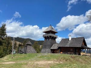 a building on top of a hill with a sky at Chata Simon in Nižná Boca