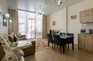 a living room with a couch and a table with chairs at Apartment in Gold Bugaz in Karolino-Buhaz