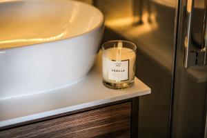a candle sitting on a counter next to a sink at Zielony Dom in Mielno +19 photos