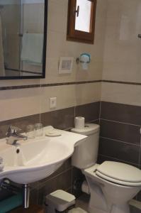 a bathroom with a toilet and a sink at La Bergerie in Joucas