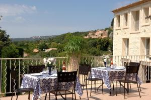a table and chairs on a balcony with a view at La Bergerie in Joucas