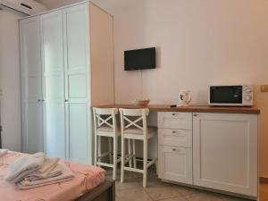 a bedroom with a desk with a tv and a bed at Apartmants Bubalo in Trpanj