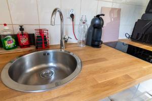 a kitchen counter with a stainless steel sink at Little GAMBETTA in Saumur