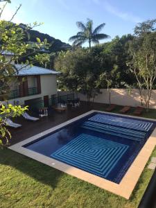 a swimming pool in the yard of a house at Foca Guest House in Búzios