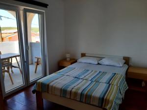 Postel nebo postele na pokoji v ubytování Apartmani Ivan