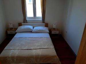 Postel nebo postele na pokoji v ubytování Apartmani Ivan