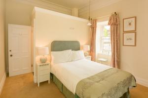 a bedroom with a bed and a window at Springkell in Eaglesfield