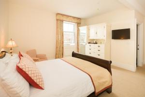 a bedroom with a large bed and a window at Springkell in Eaglesfield