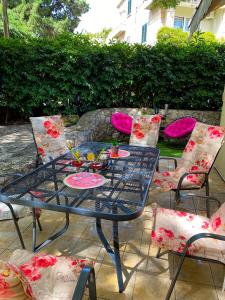 a blue table and chairs with a meal on it at Relax Apartment Lapad Dubrovnik in Dubrovnik